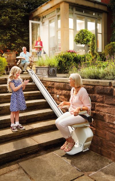 Woman enjoying the outdoors with her stairlift from Acorn Stairlift